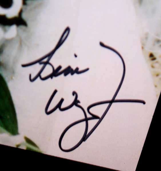 This one of a kind autograph was obtained on this 8X10 wedding photograph 